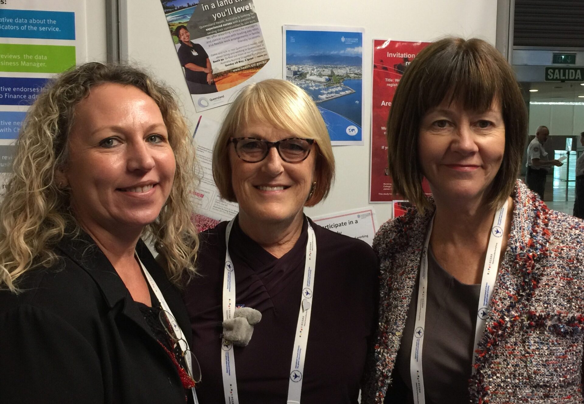 Three people smiling