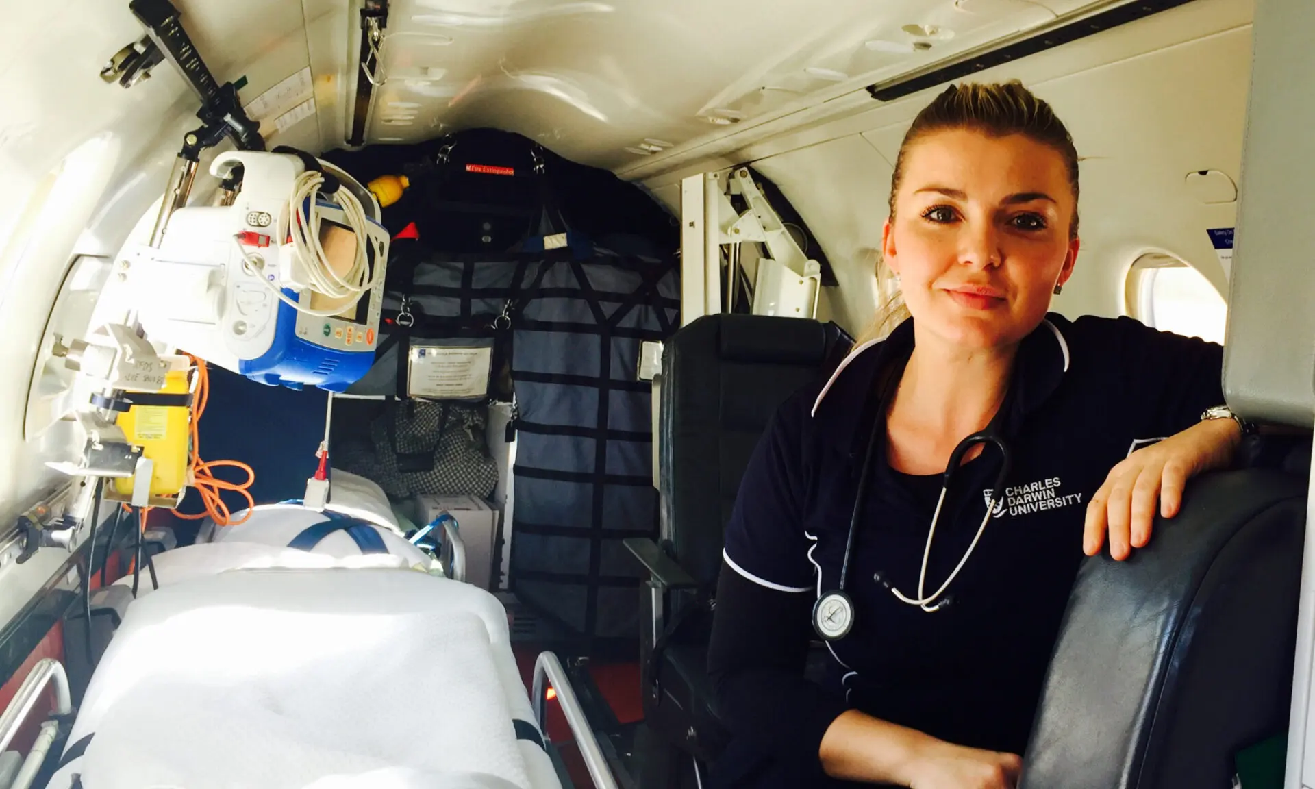 person in a medical plan wearing a Charles Darwin University polo shirt.