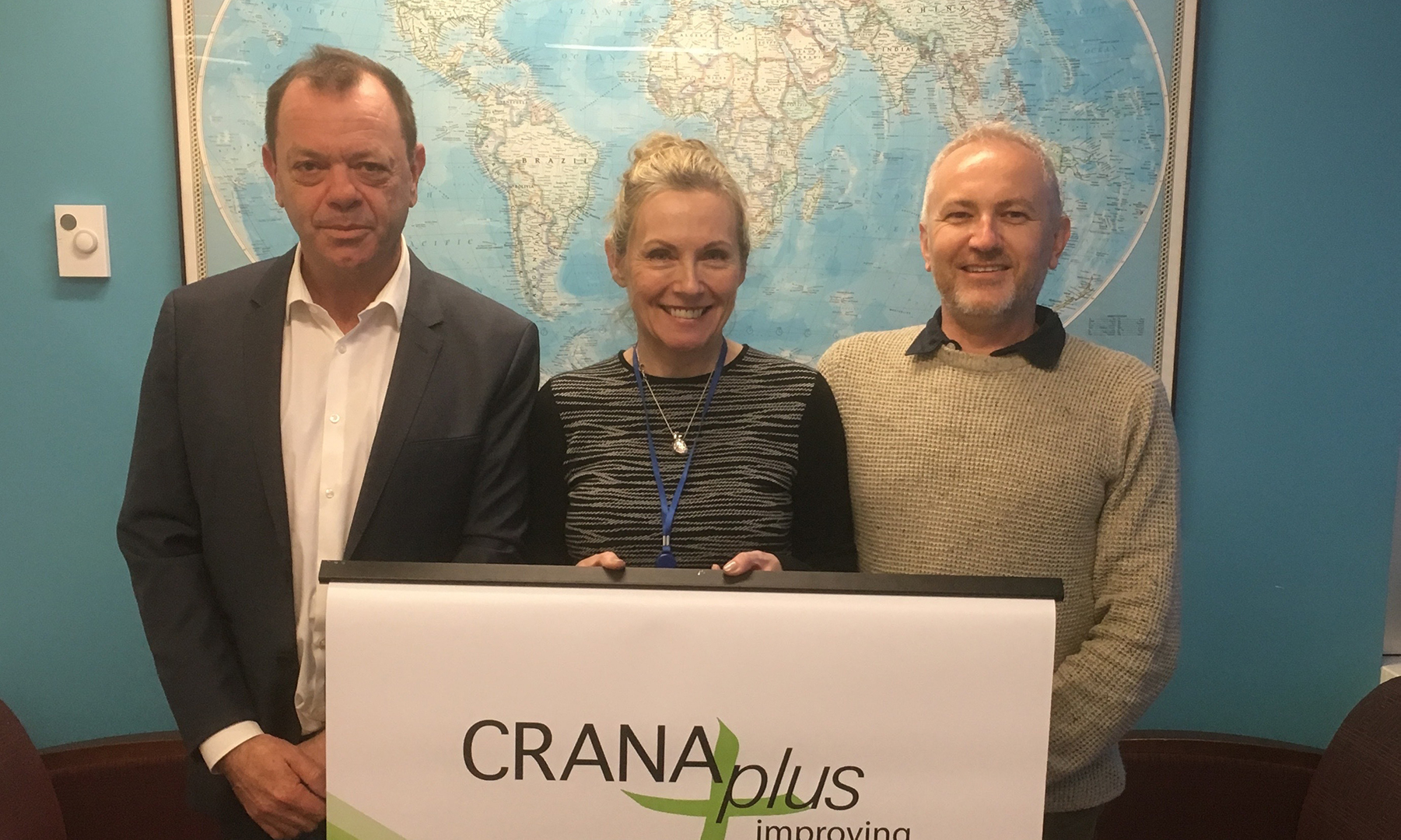 Chris Cliffe, Michael Jenkins and Sue Ellen holding a CRANAplus poster.