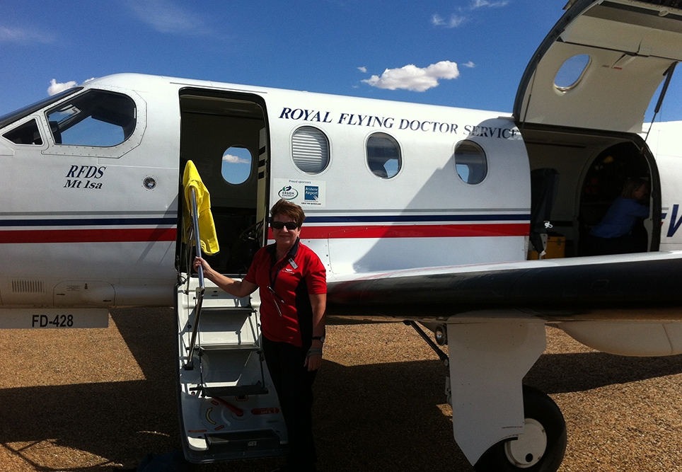 Dianne stepping out of an RFDS clinic aircraft