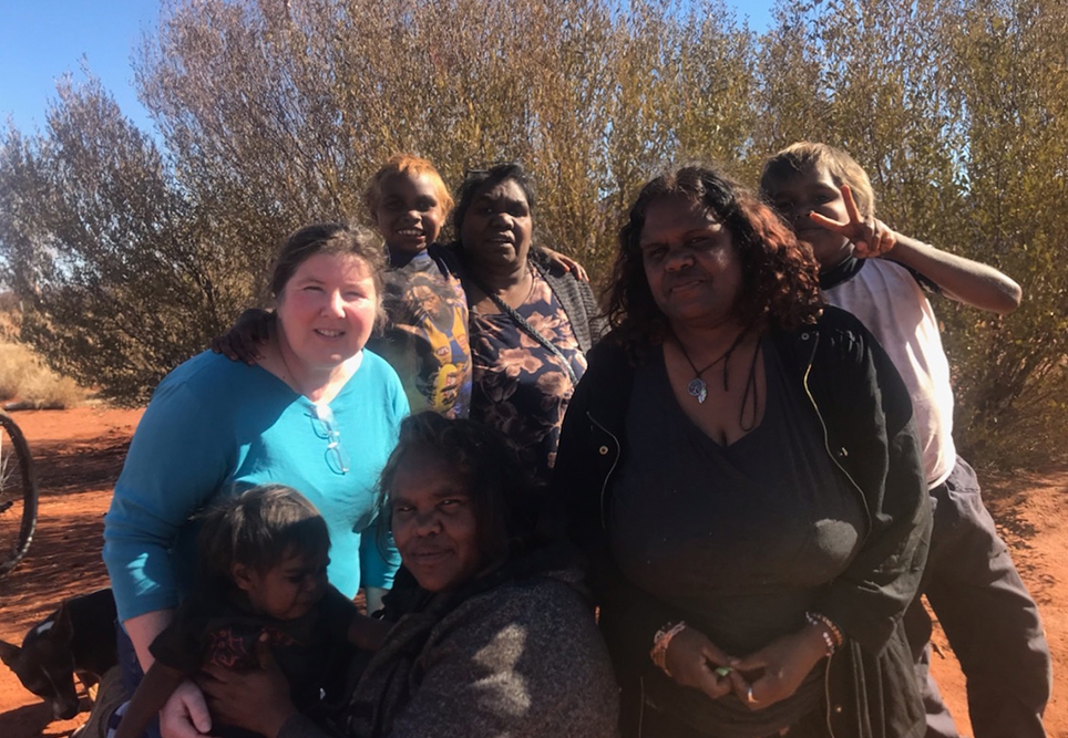 Lyn Byers with group of community members outside