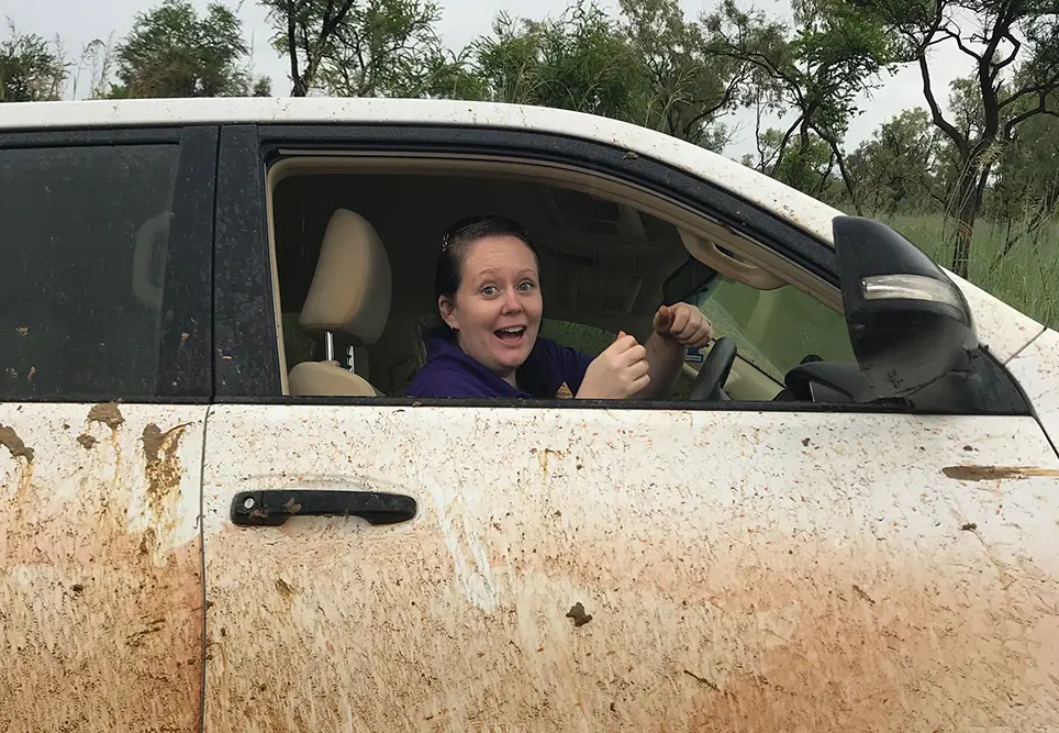 Michelle bogs the work car after heavy rains.