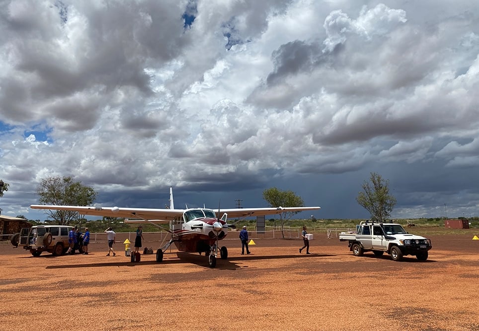 Patient handover on the tarmac at Balgo Airport.
