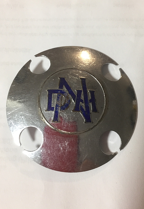 The silver nickel plate worn on a waist belt in Sandra’s early workplace.