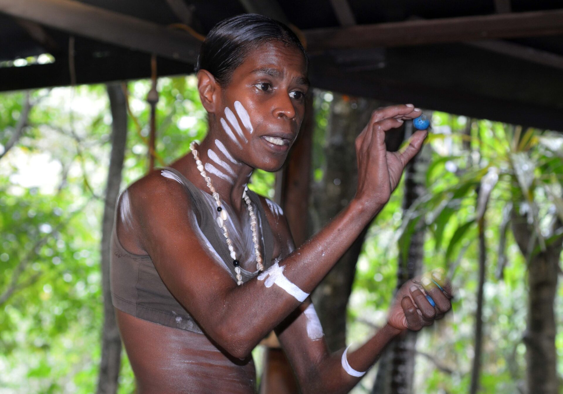 A Yirrganydji Aboriginal woman demonstrating local bush tucker. Photo credit: Rafael Ben-Ari – stock.adobe.com