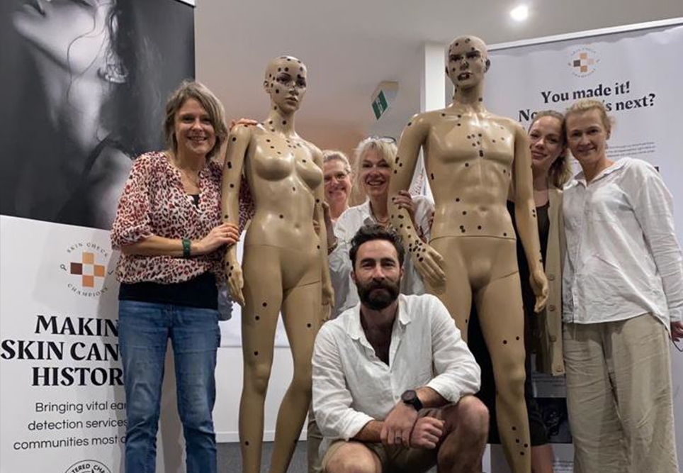 Scott Maggs, Skin Check Champions (front centre), Jane Homberger, Skin Smart Australia (centre) and nurses after a skin check pop-up clinic in September. The dots on the manikins are patient placed if they had a suspicious lesion found.